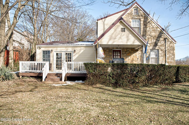 back of house featuring a wooden deck and a lawn