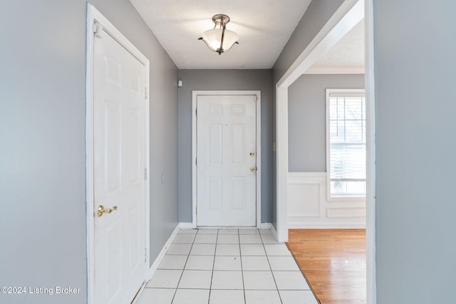 tiled foyer with a textured ceiling