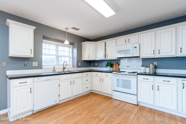 kitchen featuring sink, white cabinets, white appliances, and light wood-type flooring