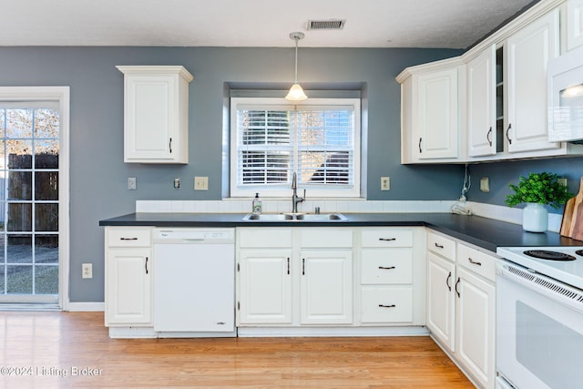 kitchen with white appliances, sink, pendant lighting, light hardwood / wood-style flooring, and white cabinetry