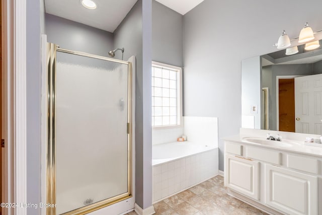 bathroom with tile patterned floors, vanity, and plus walk in shower