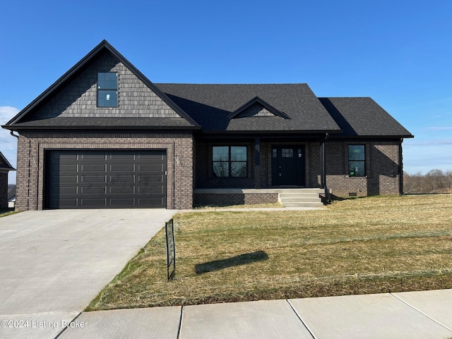 view of front of property with a front yard and a garage