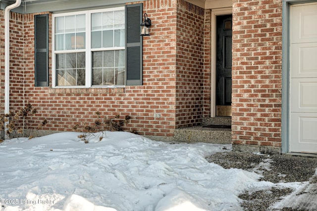 view of snow covered property entrance