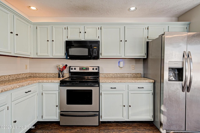 kitchen featuring light stone countertops, a textured ceiling, dark hardwood / wood-style floors, white cabinets, and appliances with stainless steel finishes