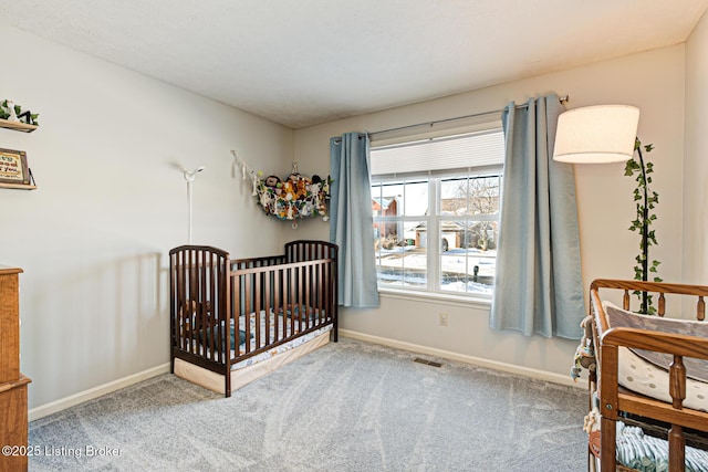 carpeted bedroom featuring a crib