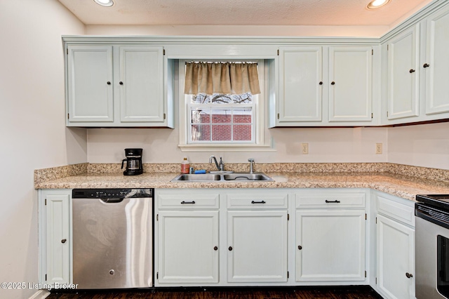 kitchen with stainless steel appliances, white cabinetry, and sink