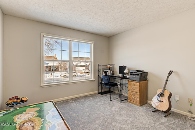 carpeted home office featuring a textured ceiling