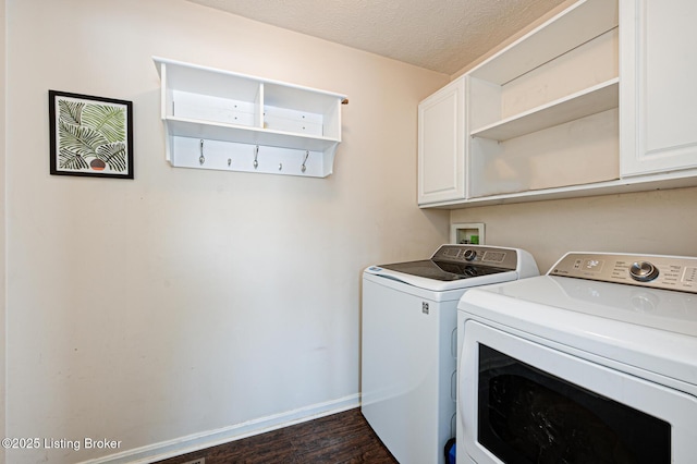 washroom with a textured ceiling, cabinets, separate washer and dryer, and dark hardwood / wood-style flooring