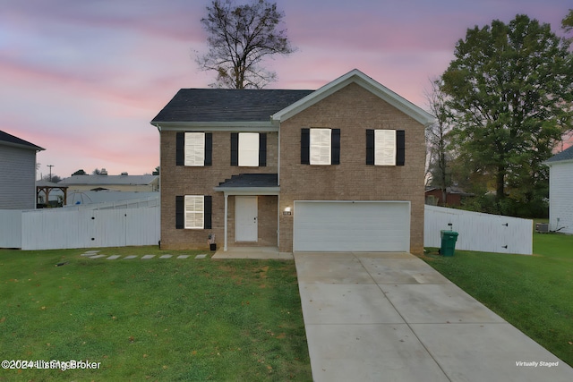 front facade with a lawn and a garage