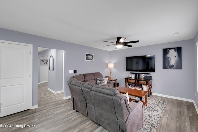 living room featuring ceiling fan and light hardwood / wood-style flooring