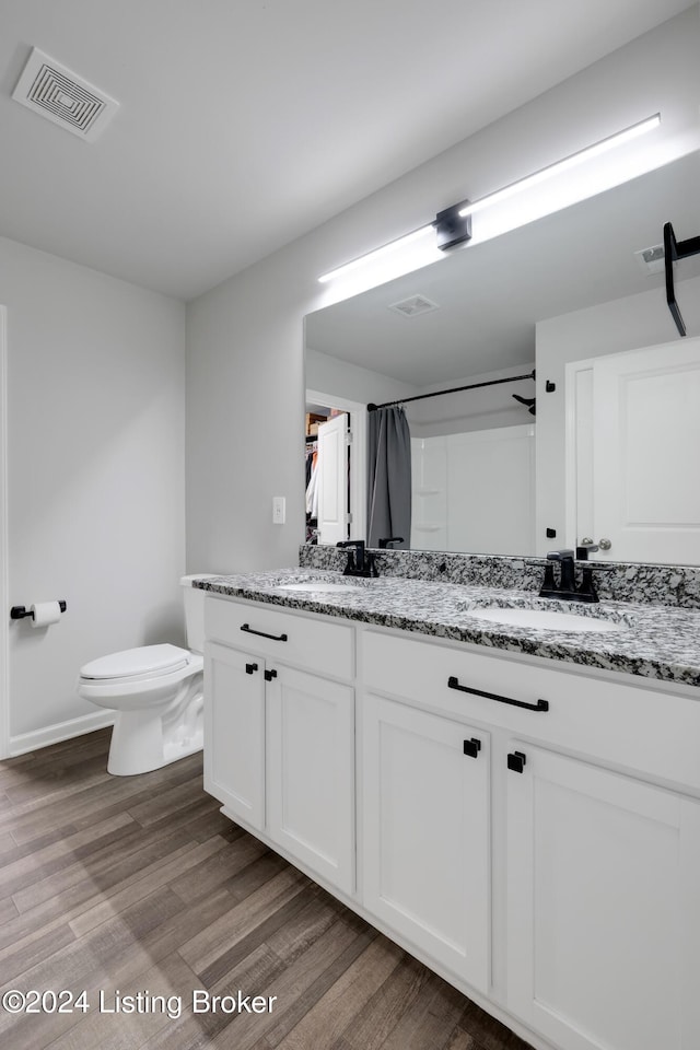 bathroom featuring a shower with curtain, toilet, vanity, and hardwood / wood-style flooring