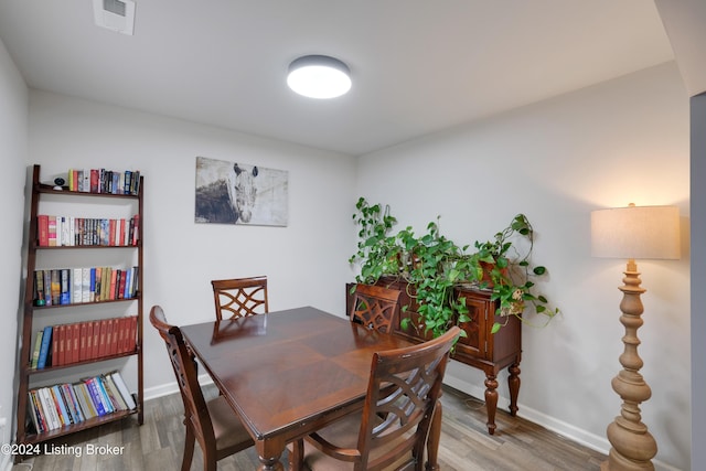 dining room with wood-type flooring