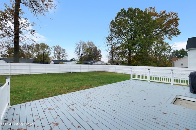 wooden terrace featuring a yard