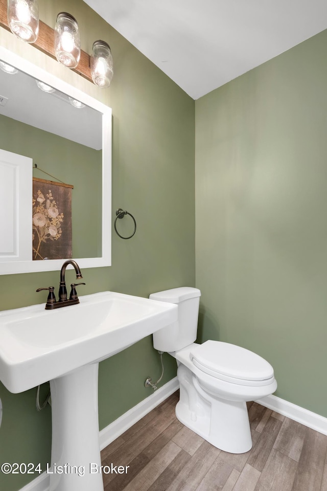 bathroom with sink, toilet, and hardwood / wood-style flooring