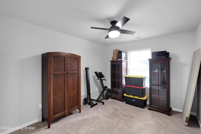 interior space featuring ceiling fan and light colored carpet