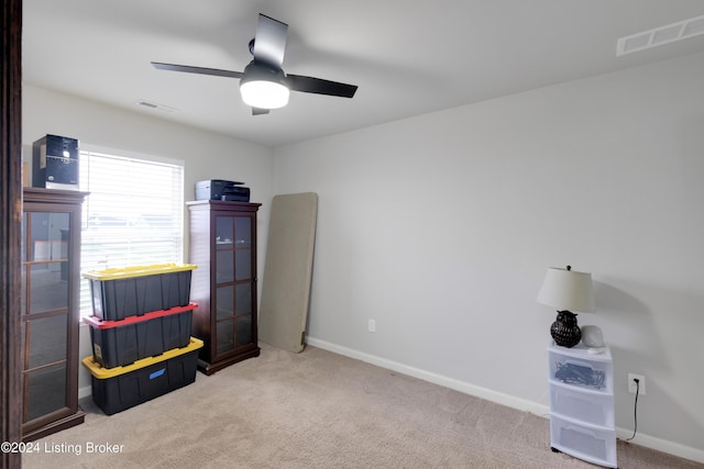 misc room featuring ceiling fan and light colored carpet