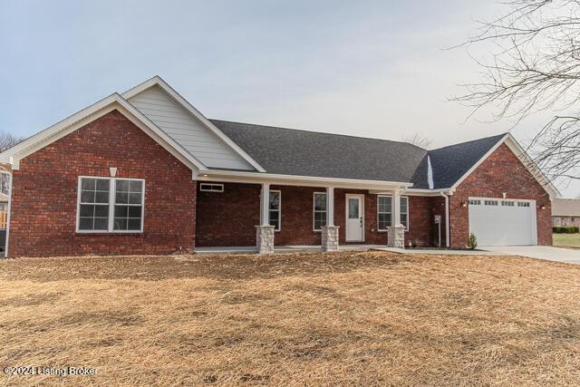 363 S Hamilton Ave, Hanover, IN 47243 - ranch-style house with brick siding, concrete driveway, a garage, and a porch