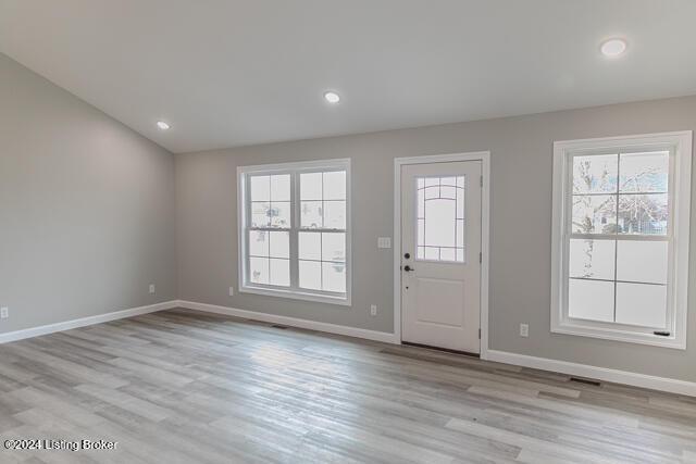 entryway featuring light hardwood / wood-style floors and vaulted ceiling