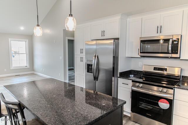 363 S Hamilton Ave, Hanover, IN 47243 - kitchen with stainless steel appliances, white cabinetry, a kitchen island, dark stone counters, and decorative light fixtures