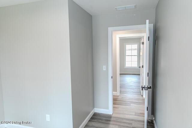 corridor with light hardwood / wood-style flooring