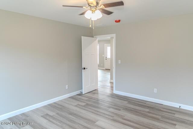 empty room with light hardwood / wood-style flooring and ceiling fan