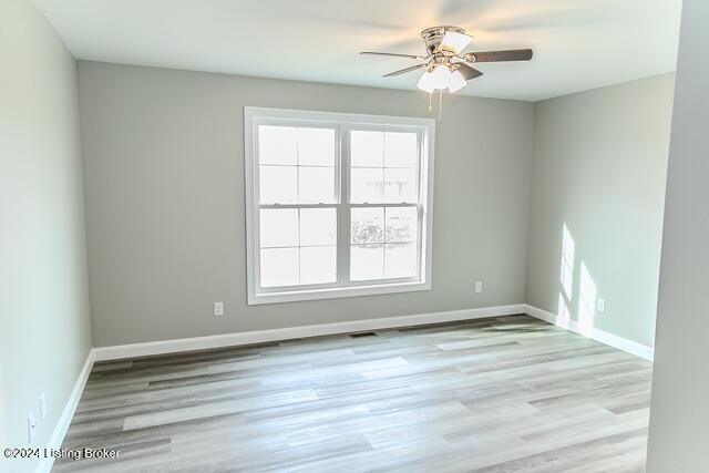 spare room with ceiling fan and light hardwood / wood-style flooring