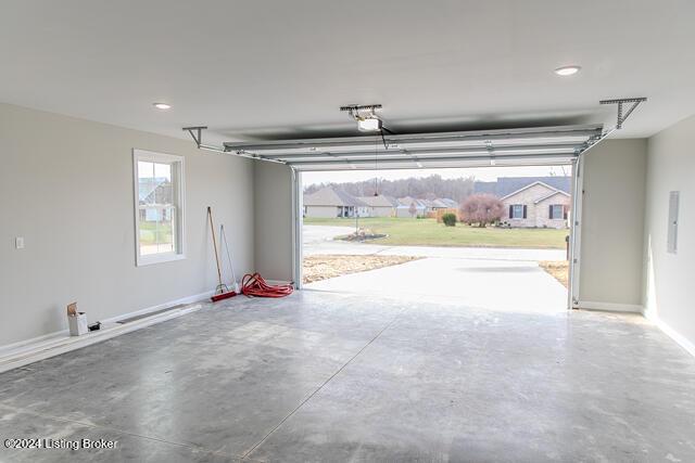 363 S Hamilton Ave, Hanover, IN 47243 - garage featuring electric panel, a garage door opener, and recessed lighting