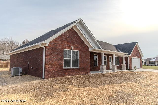 363 S Hamilton Ave, Hanover, IN 47243 - view of front facade with covered porch, brick siding, a garage, and concrete driveway