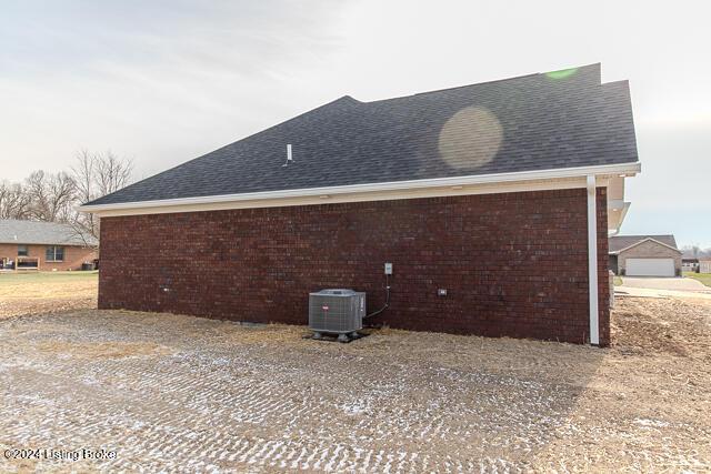 view of side of home featuring central AC unit