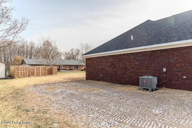 view of side of home with central AC unit