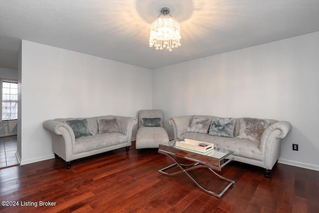 living room with dark hardwood / wood-style floors and a notable chandelier