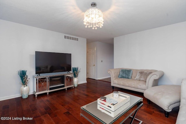 living room featuring dark hardwood / wood-style flooring and a chandelier