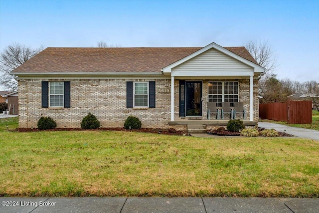 ranch-style home featuring a porch and a front lawn