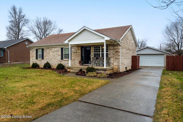 ranch-style house featuring a front yard, covered porch, an outdoor structure, and a garage