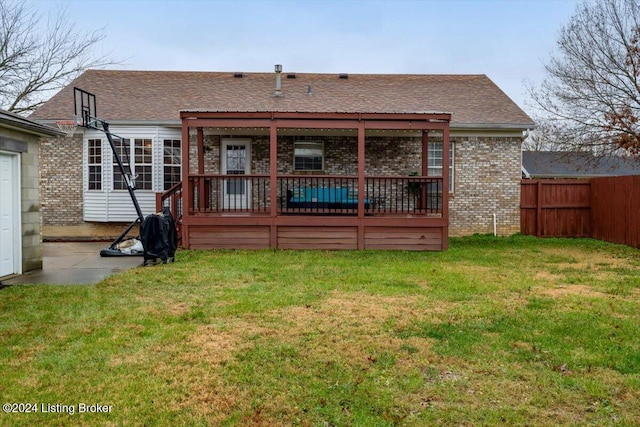 rear view of property with a lawn
