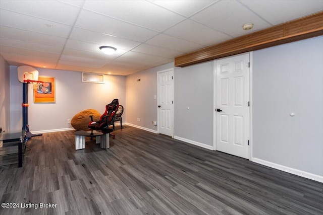 sitting room with a paneled ceiling and dark hardwood / wood-style floors