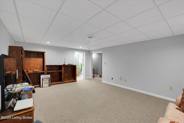 interior space featuring a drop ceiling and carpet