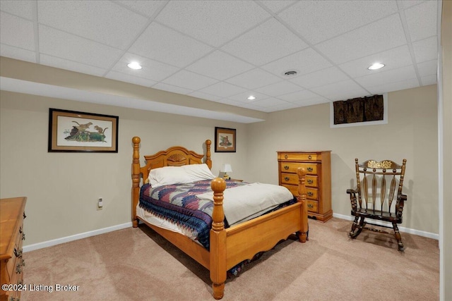 carpeted bedroom featuring a paneled ceiling