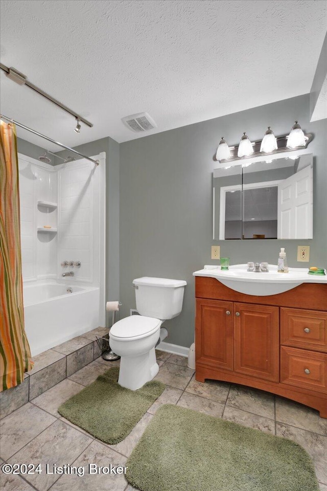 full bathroom featuring vanity, toilet, a textured ceiling, and shower / washtub combination