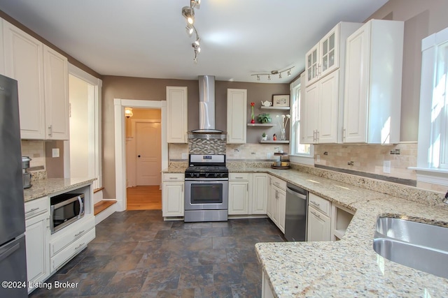 kitchen featuring white cabinets, sink, wall chimney exhaust hood, and stainless steel appliances