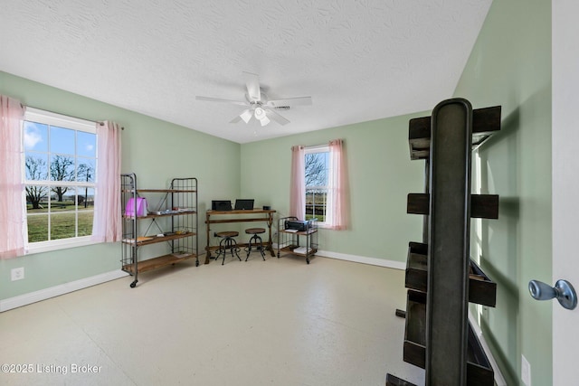 office space featuring ceiling fan and a textured ceiling