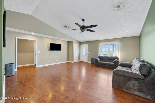 living room with wood-type flooring, a textured ceiling, vaulted ceiling, and ceiling fan