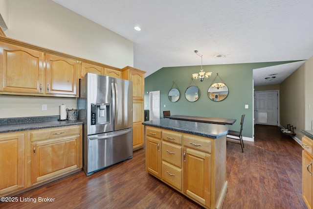 kitchen featuring dark wood-type flooring, pendant lighting, a notable chandelier, stainless steel fridge with ice dispenser, and a center island