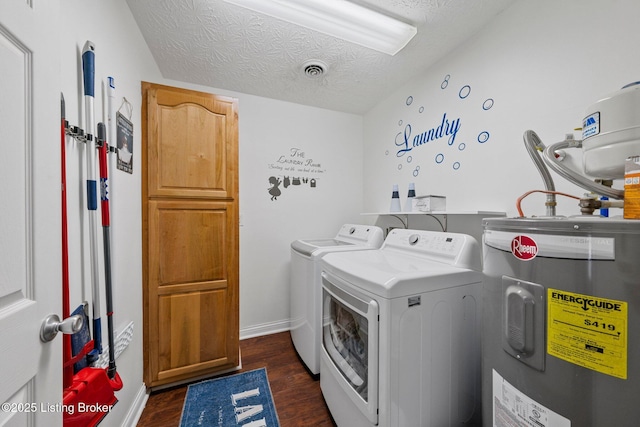 laundry room featuring dark hardwood / wood-style flooring, electric water heater, a textured ceiling, and separate washer and dryer