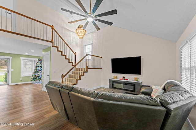 living room with wood-type flooring, high vaulted ceiling, a wealth of natural light, and ceiling fan