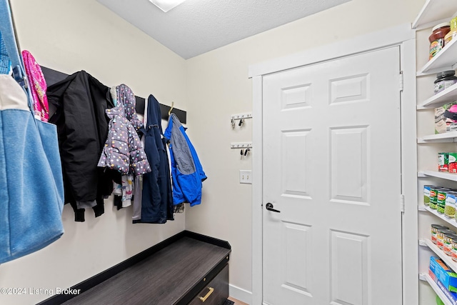 mudroom featuring a textured ceiling