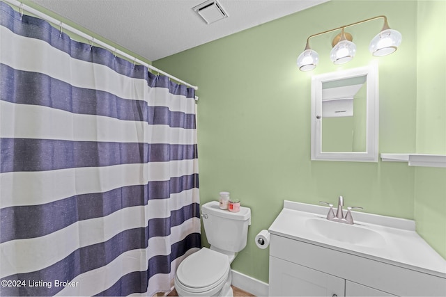 bathroom featuring a shower with curtain, vanity, a textured ceiling, and toilet