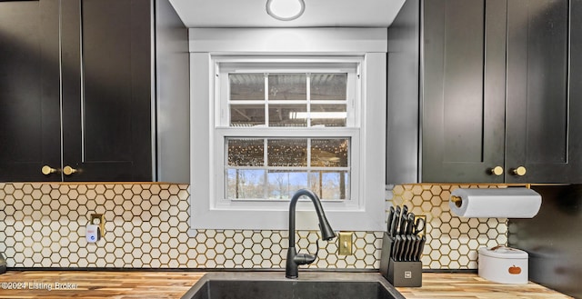 kitchen with backsplash, light hardwood / wood-style flooring, and sink