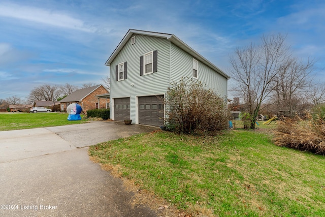 view of home's exterior with a garage and a lawn