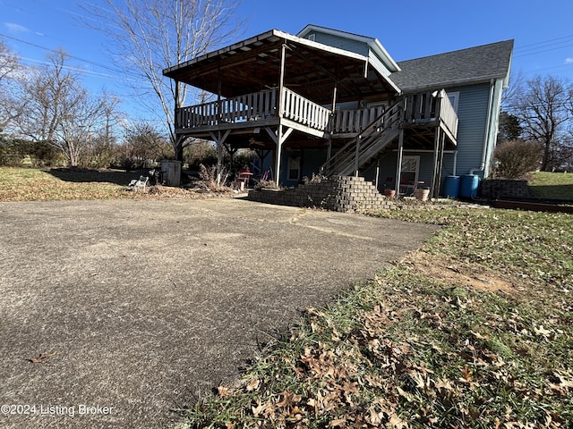 rear view of property with a wooden deck